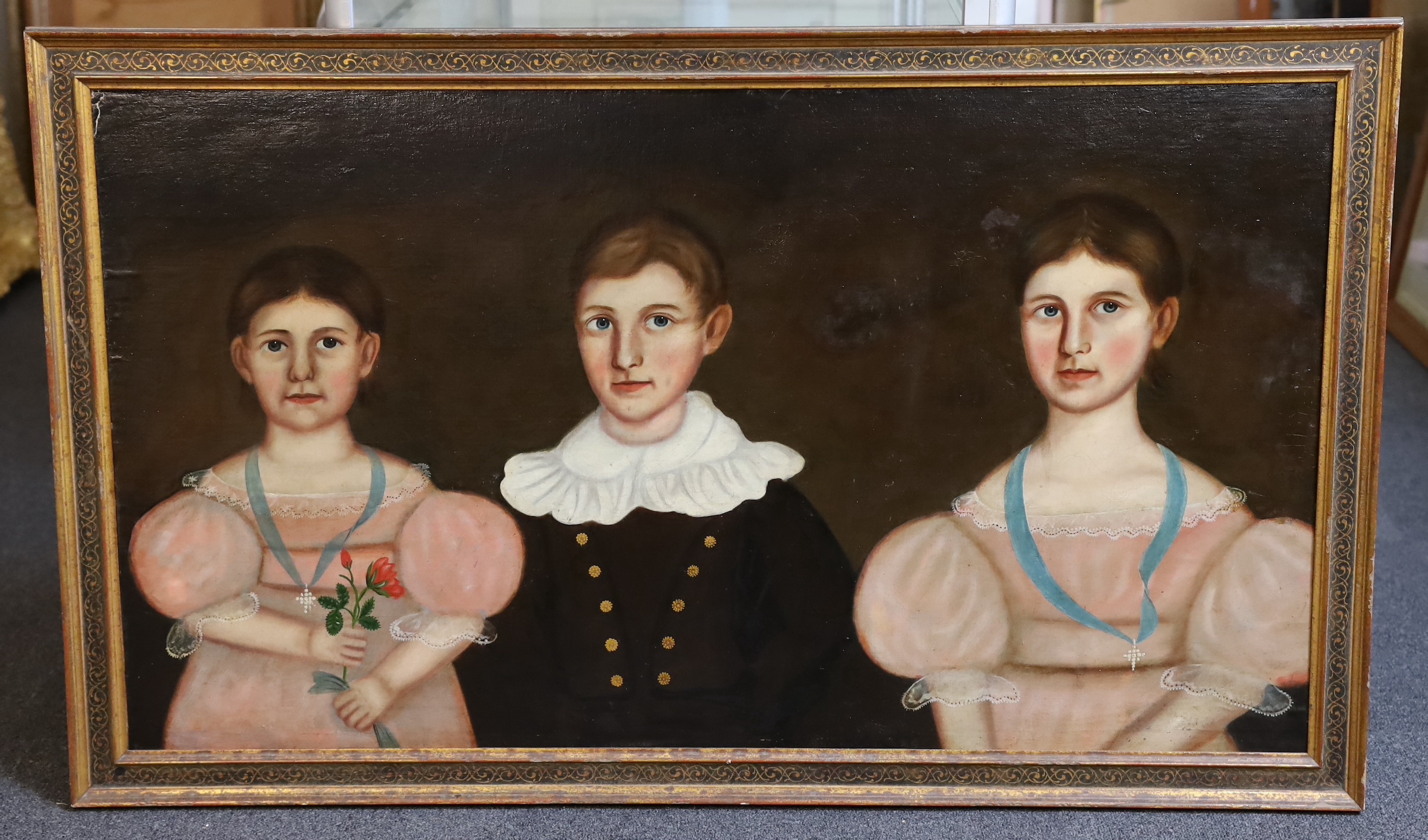 American Primitive School , Portrait of three children of the Burgess family, oil on canvas laid on board, 60 x 107cm